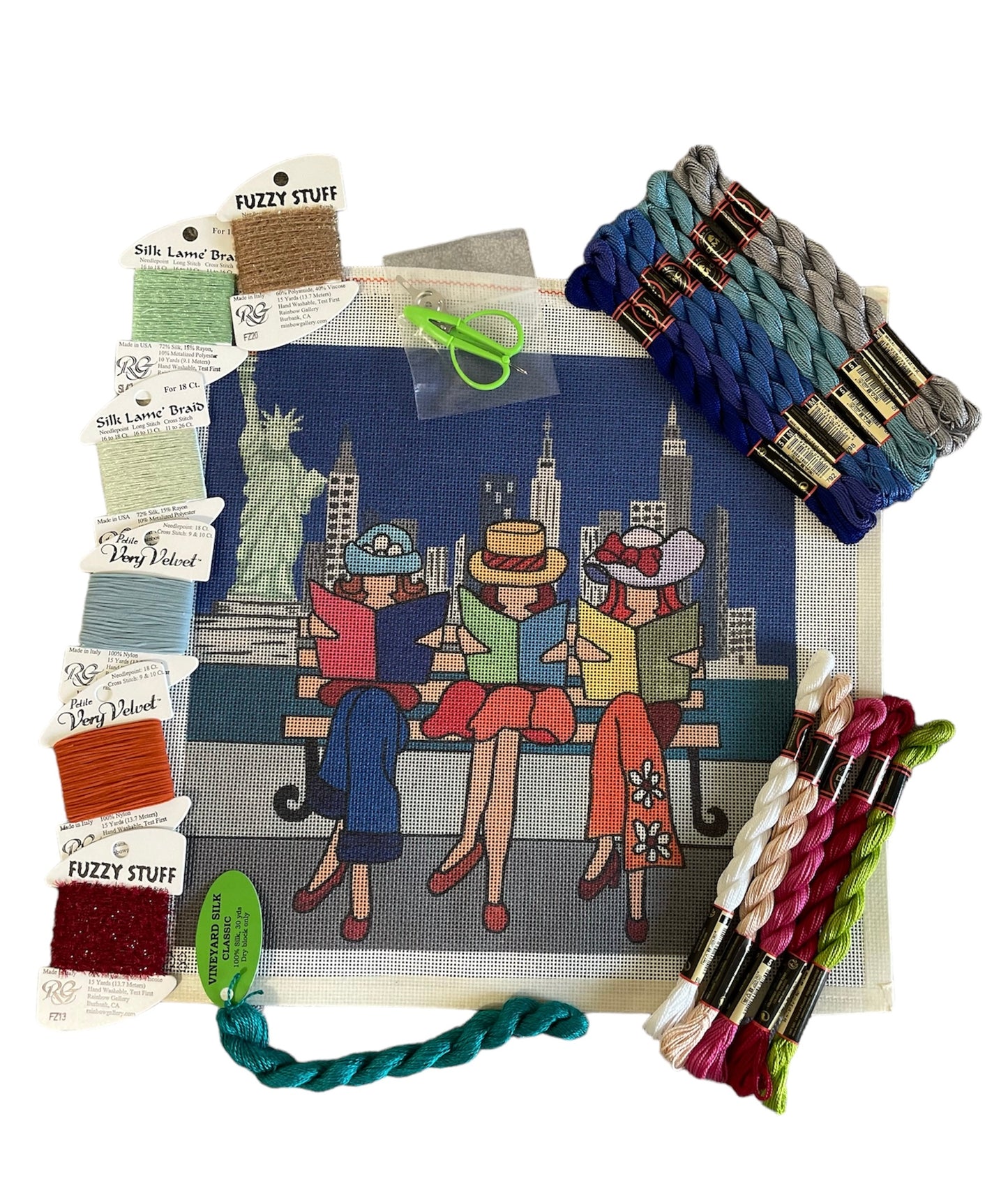 New York City-inspired needlepoint kit with lady figures against a cityscape, complete with colorful threads and Silk Lamé Braid.